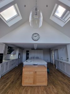 a contemporary kitchen illuminated by two skylight windows rotated