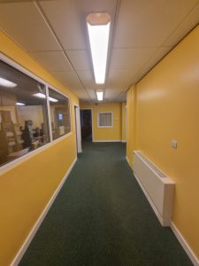 a hallway with yellow painted walls scaled