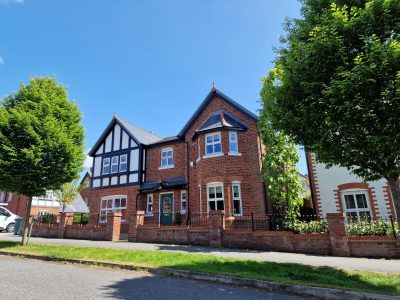 a large red brick double fronted building