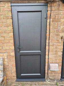 a modern exterior door painted black scaled