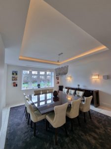 a square dining table taking centre stage in a room featuring white walls painted by mc painters rotated