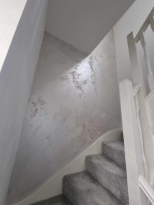 a white banister and metalic silver wallpaper rotated