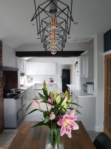 a white kitchen set against pristine white walls rotated