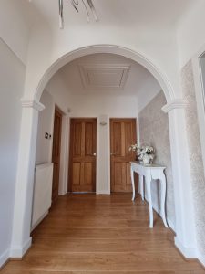 an archway in a hallway painted white by mc painters rotated