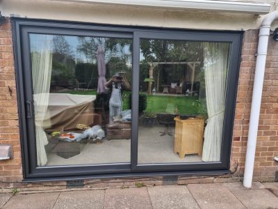 external view of sliding doors painted in a modern black colour scaled