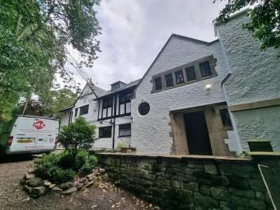 the exterior of a large home painted white
