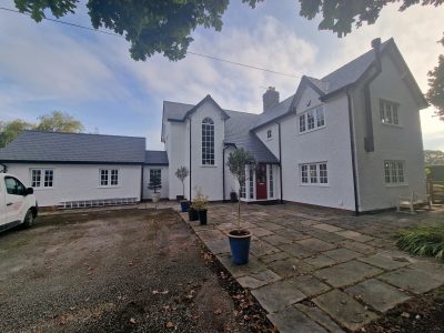the exterior of a large home recently decorated in a fresh white colour