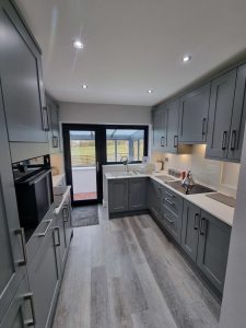 white walls of a kitchen set against grey cupboards rotated
