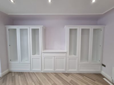 white wardrobes against a lilac wall scaled