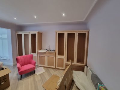 wooden wardrobes against a lilac wall ready for painting scaled